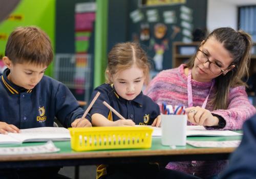 Primary school teacher showcasing teaching methods in the classroom