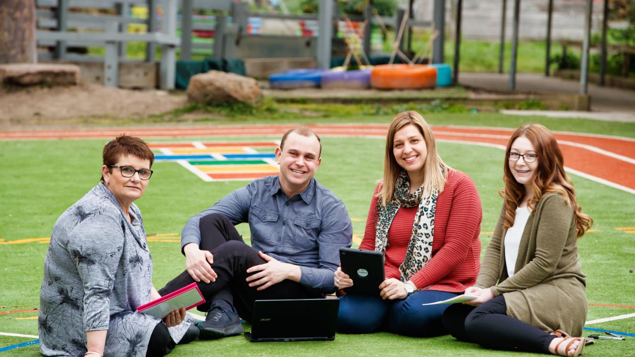 Group of teachers sitting outdoors