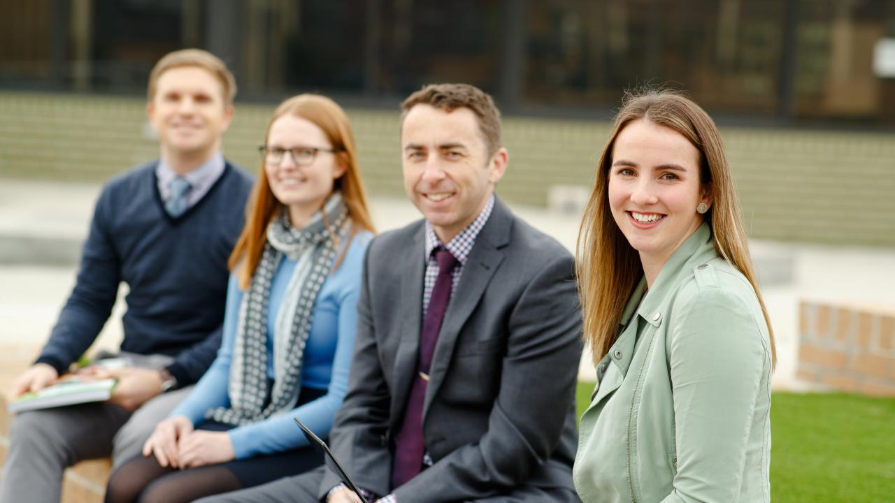 Group of teachers sitting outdoors