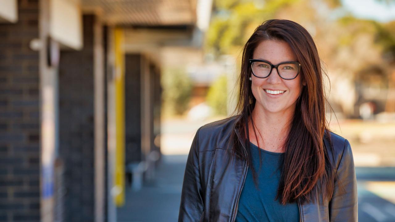 Female teacher outside school building