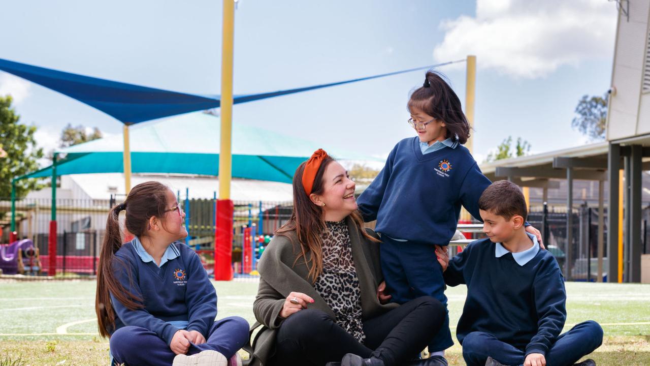 Teacher with young students outside