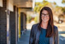 Female teacher outside school building