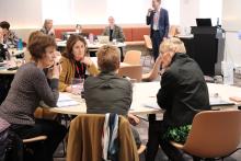 A group of participants seated at a table in collaboration during a workshop