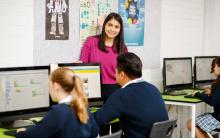 Teacher with high school students in computer lab