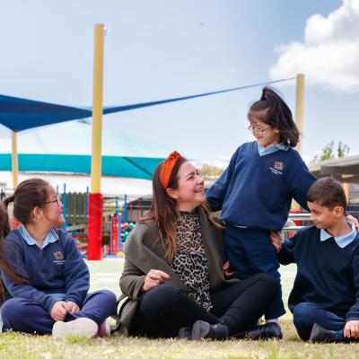 Teacher with young students outside